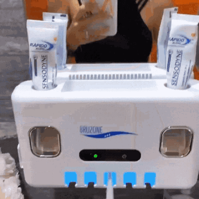 a toothpaste dispenser with two tubes of sensodyne rapido and sensodyne bruzone