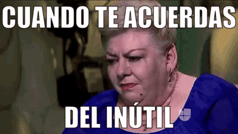a woman in a blue dress is crying with a caption that says cuando te acuerdas del inutil