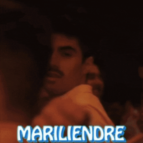 a man with a mustache is being hugged by a woman with mariliendre written in blue letters