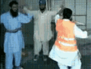 a man in a white shirt with the letter s on it stands next to a woman in an orange vest