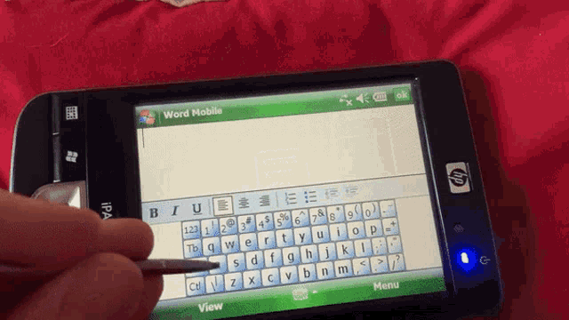 a person is typing on a hp phone