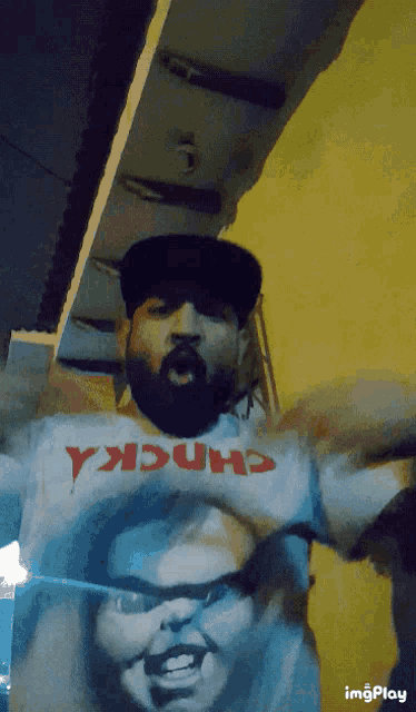 a man with a beard wearing a chucky shirt