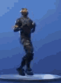 a statue of a man wearing headphones and a helmet is dancing on a table .