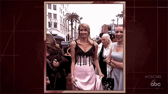 a photo of a woman in a pink dress is displayed on a abc screen