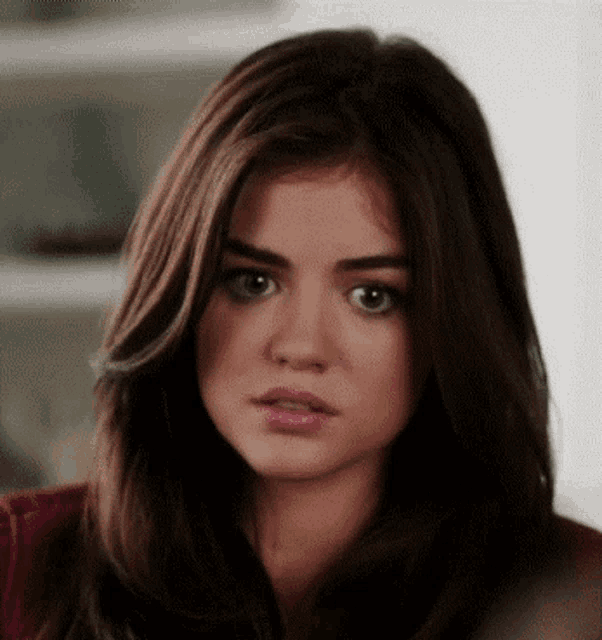 a close up of a woman 's face with brown hair