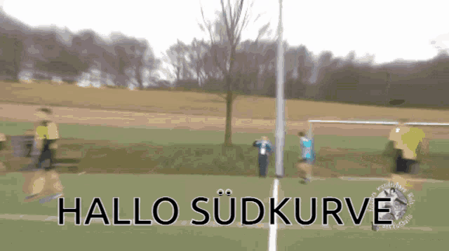 a blurry picture of a soccer field with the words hallo sudkurve