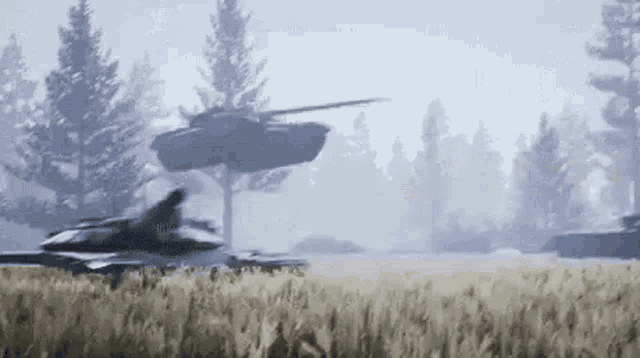 a fighter jet is flying over a field of tall grass .