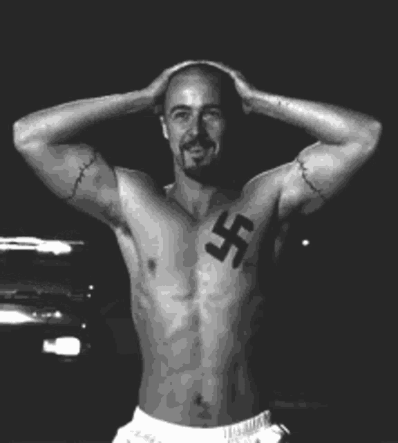 a shirtless man with a swastika on his chest