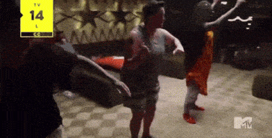 a group of people are dancing in front of a tv screen that says tv 14 l