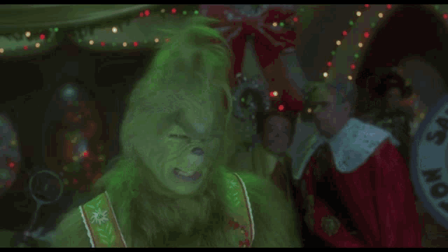 a grinch says " come on while i 'm young " while holding a magnifying glass
