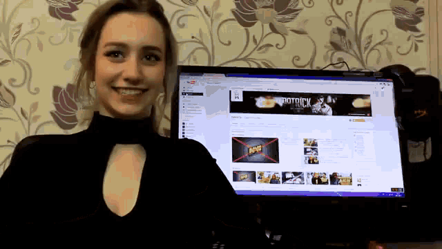 a woman is standing in front of a computer screen that says patrick