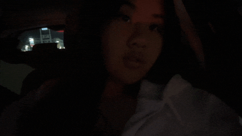 a woman is sitting in the back seat of a car