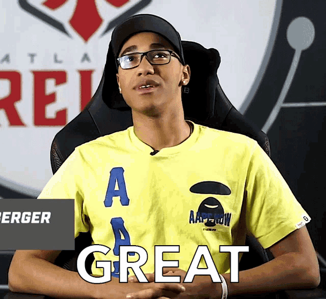 a young man wearing a yellow shirt that says great