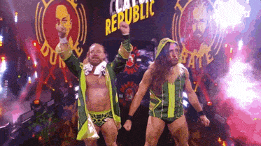 two wrestlers are standing in front of a banner that says republic