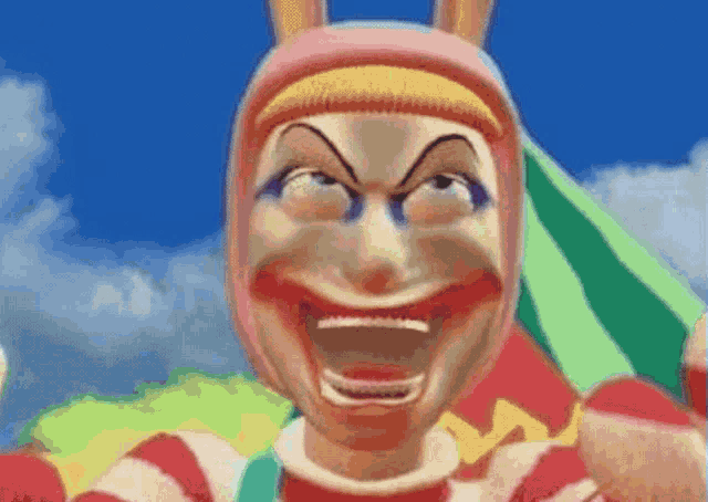 a close up of a clown making a funny face with his mouth wide open