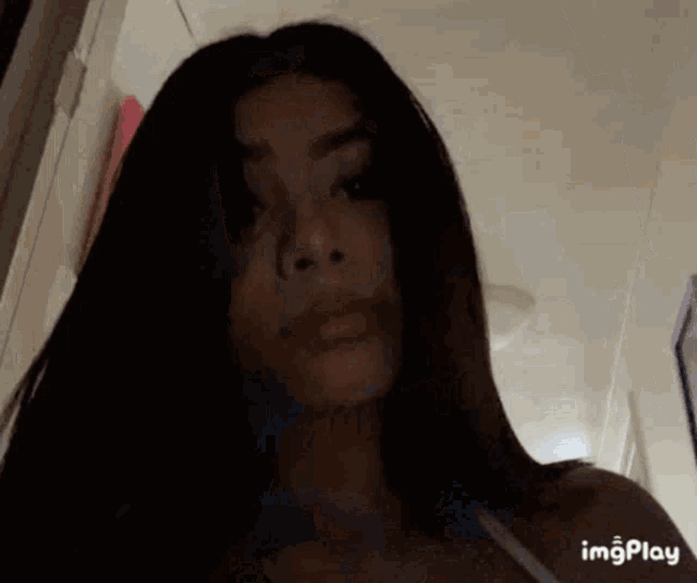 a close up of a woman 's face with a gif that says imgplay