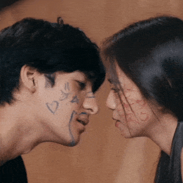 a man and a woman looking at each other with hearts and stars drawn on their faces