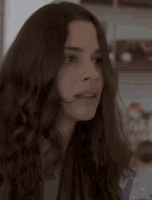a close up of a woman 's face with her mouth open