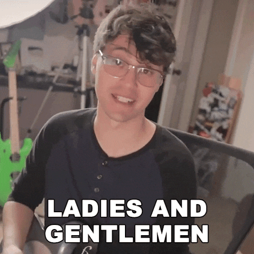 a man wearing glasses says " ladies and gentlemen " in front of a green guitar