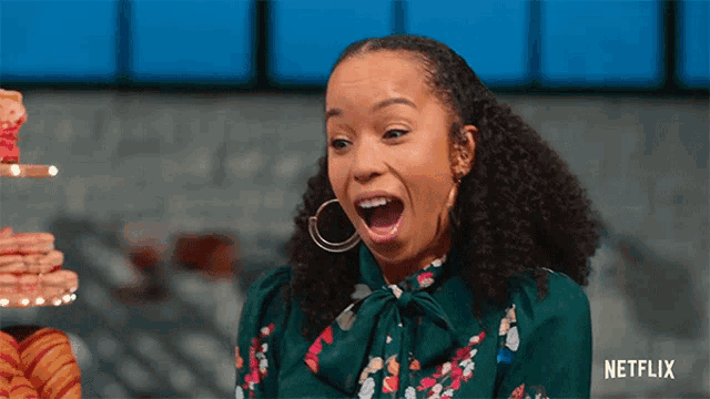 a woman with a surprised look on her face and a netflix logo behind her