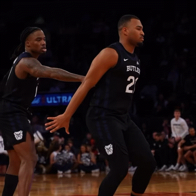 a basketball player with the number 21 on his jersey is running on the court