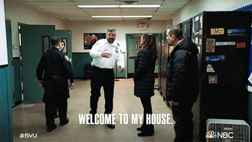 a group of people standing in a hallway with the words welcome to my house written on the floor