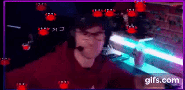 a man wearing a red hoodie and glasses is playing a video game on a computer .