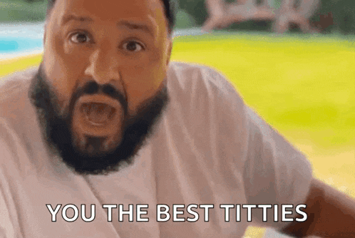 a man with a beard is saying `` you the best titties '' while standing in front of a pool .