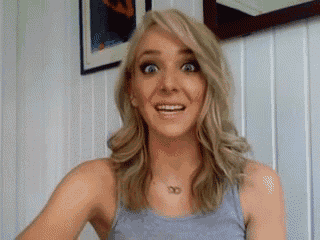 a woman with blonde hair and a necklace with the letter o on it