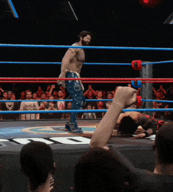 a man in a wrestling ring with a t-shirt that says ' smackdown '