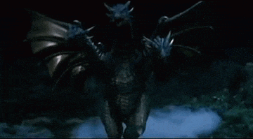 a dragon with two heads and wings is standing in the dark in the woods .