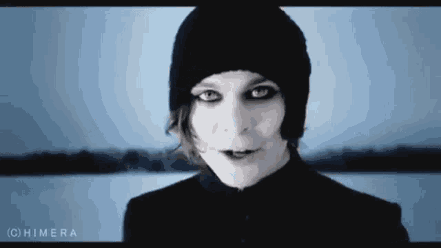 a close up of a person wearing a black beanie