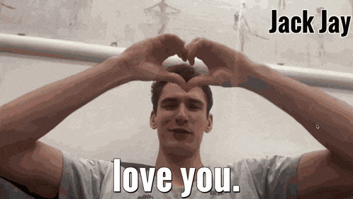 a man making a heart shape with his hands and the words " love you " above him