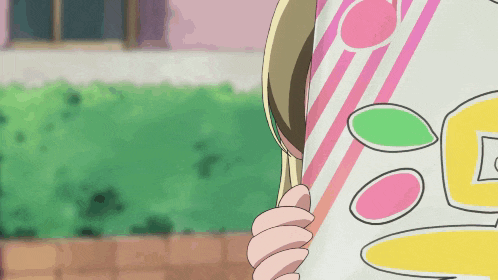a girl is holding a piece of paper with a pink and yellow circle on it