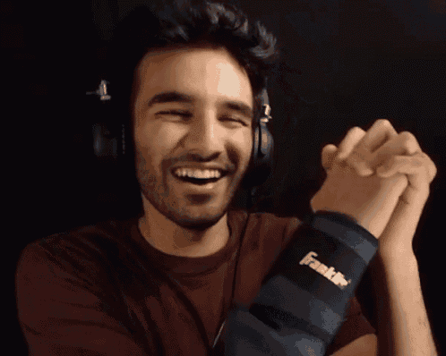 a man wearing headphones and a wristband that says ' ikill '
