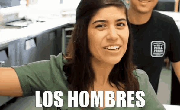 a woman in a green shirt with the words los hombres written on her chest