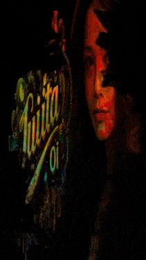 a woman 's face is behind a sign that says juiita