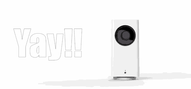 a white camera is sitting on a white surface next to the word yay