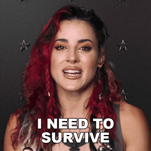 a woman with red hair is smiling and says i need to survive