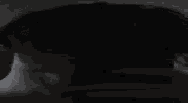 a close up of a person 's head in the dark .