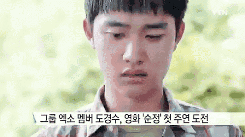 a close up of a young man 's face with a foreign language on the bottom .
