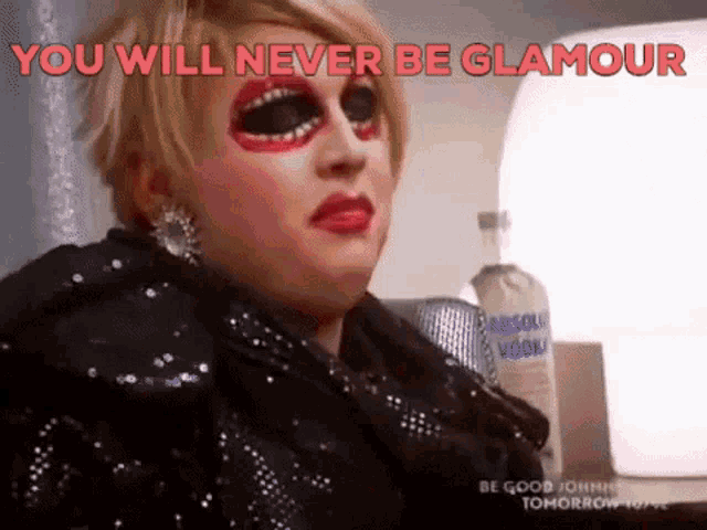 a drag queen says " you will never be glamour " in red letters