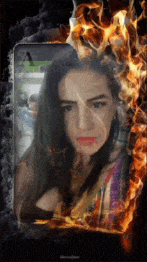 a woman 's face is surrounded by fire and the letter a is on the screen