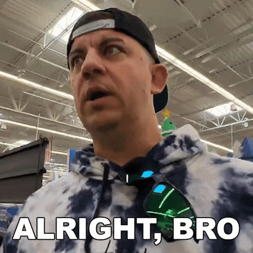 a man wearing sunglasses and a tie dye hoodie says " alright bro "