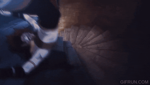a person is walking up a spiral staircase with gifrun.com written on the bottom right