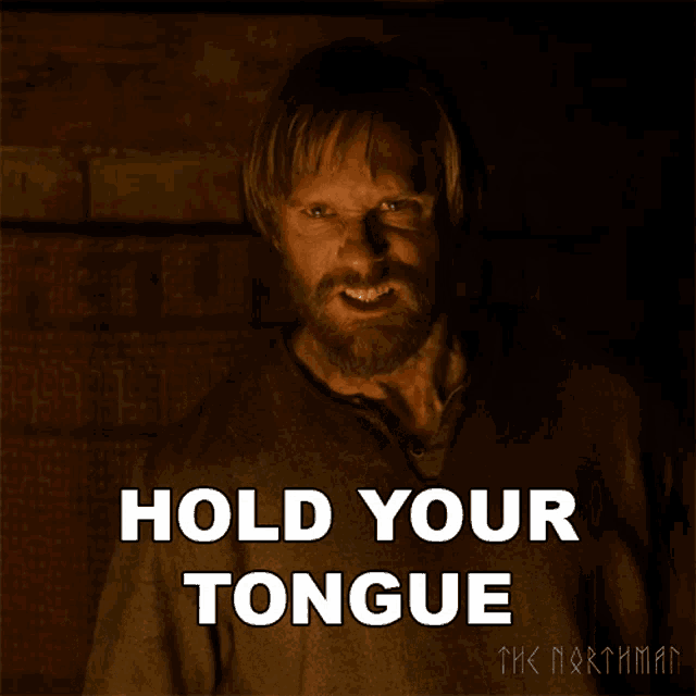 a man with a beard is holding his tongue