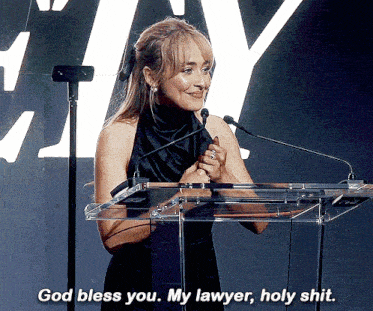 a woman stands at a podium and says " god bless you "