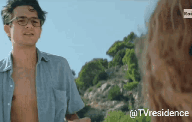 a man without a shirt is standing next to a woman with the hashtag @tvresidence at the bottom