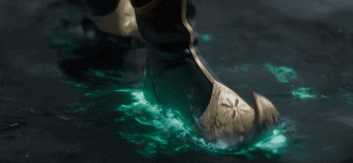 a close up of a pendant with a green light coming out of it .