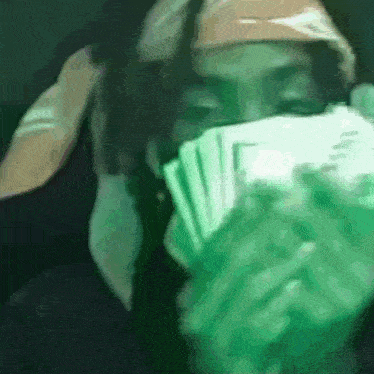 a blurry picture of a person holding a stack of cards